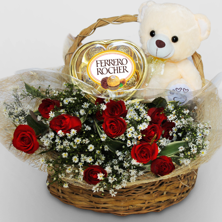Basket of twelve roses, chocolate, and bear
