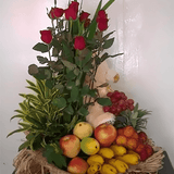 Basket of fruit with six red roses